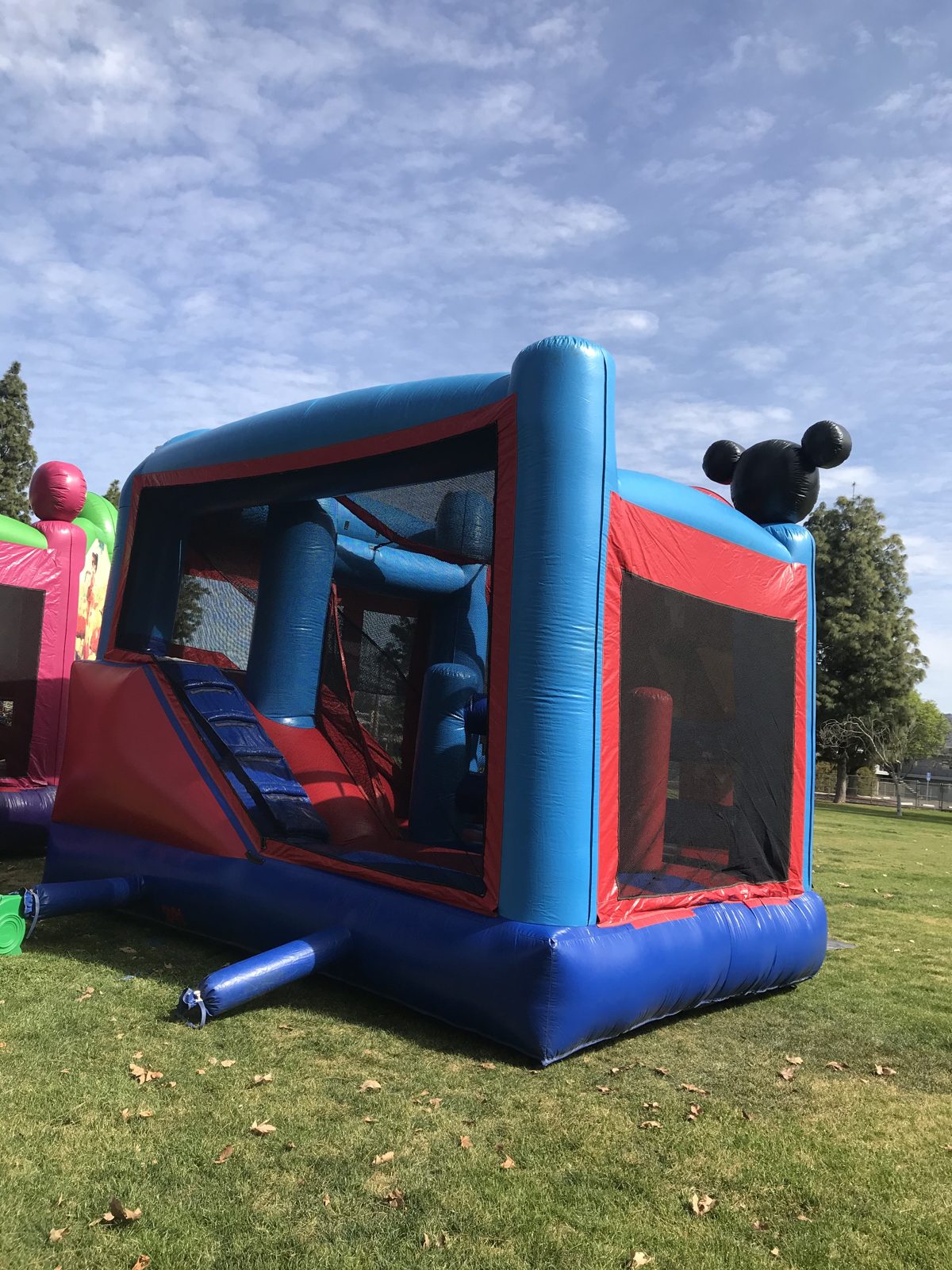 5n1 Mickey combo bounce house rental in San Diego, angled side view of the slide and climbing obstacles