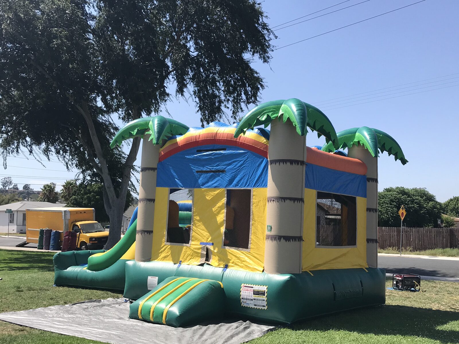 3n1 palm tree combo bounce house rental in San Diego, side view showing the palm tree column and mesh jump-area window