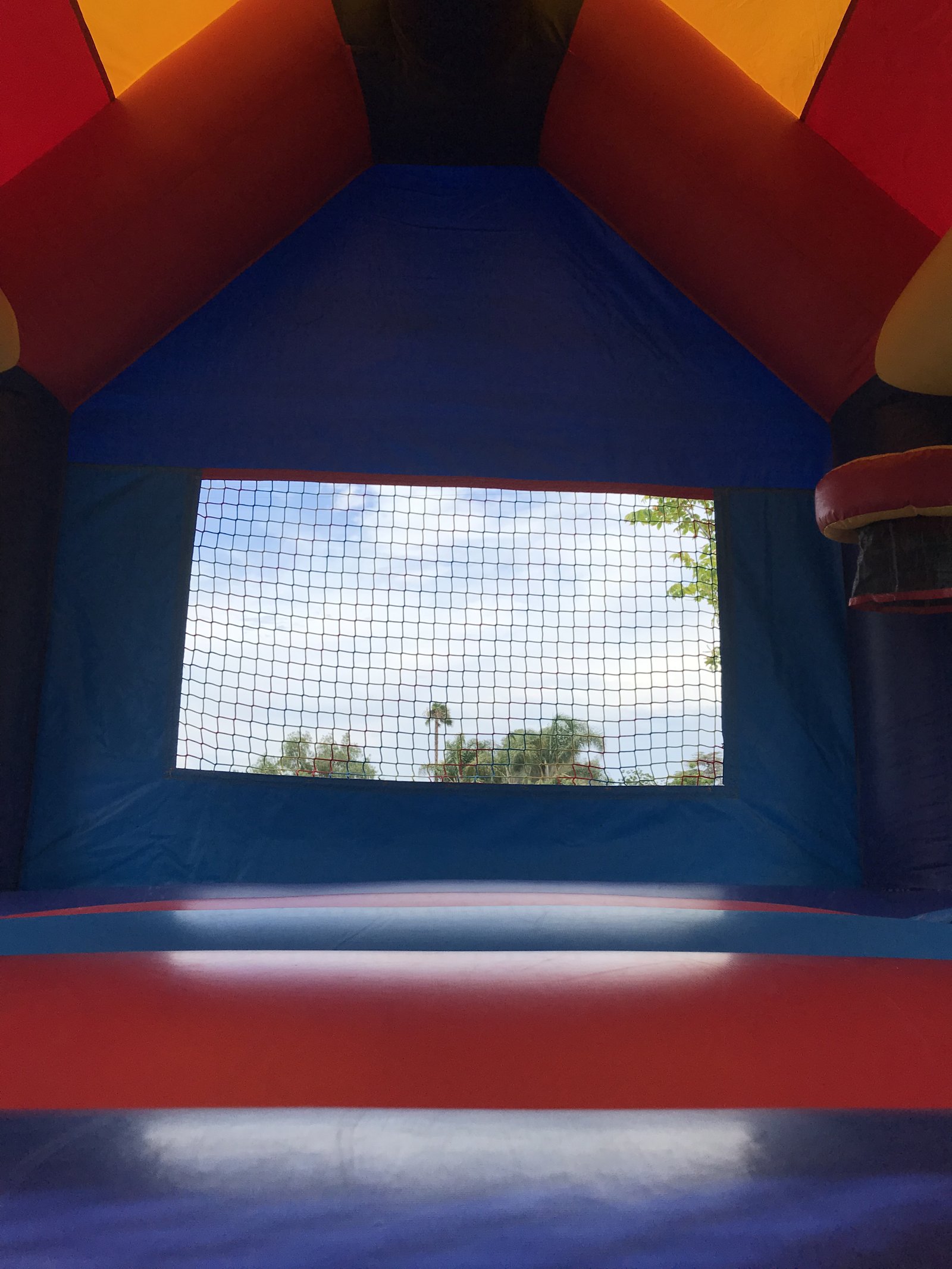 13x13 Spider-Man bounce house rental in San Diego — inside view of the jumping floor looking out the large mesh safety window