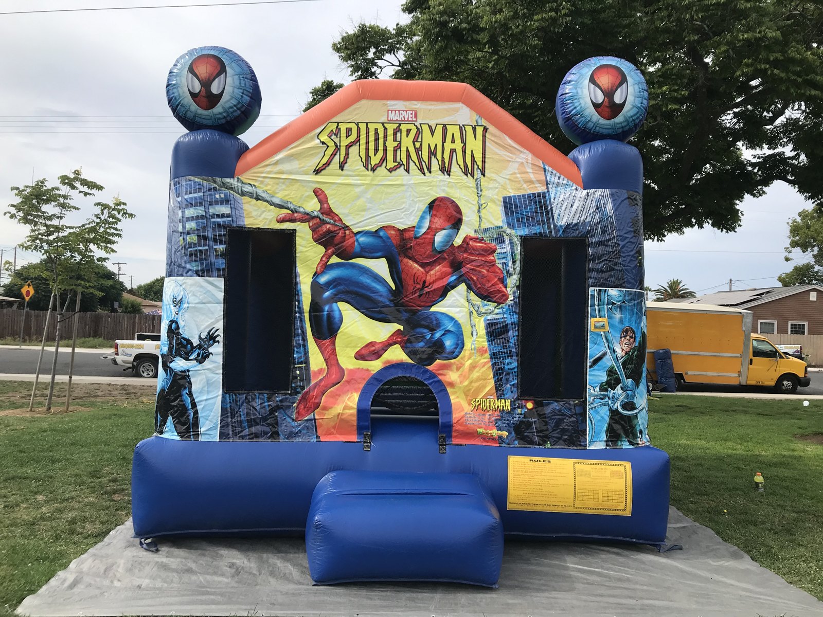 13x13 Original Spider-Man bounce house rental in San Diego — straight-on front view with classic Marvel Spider-Man artwork and twin Spider-Man ball toppers