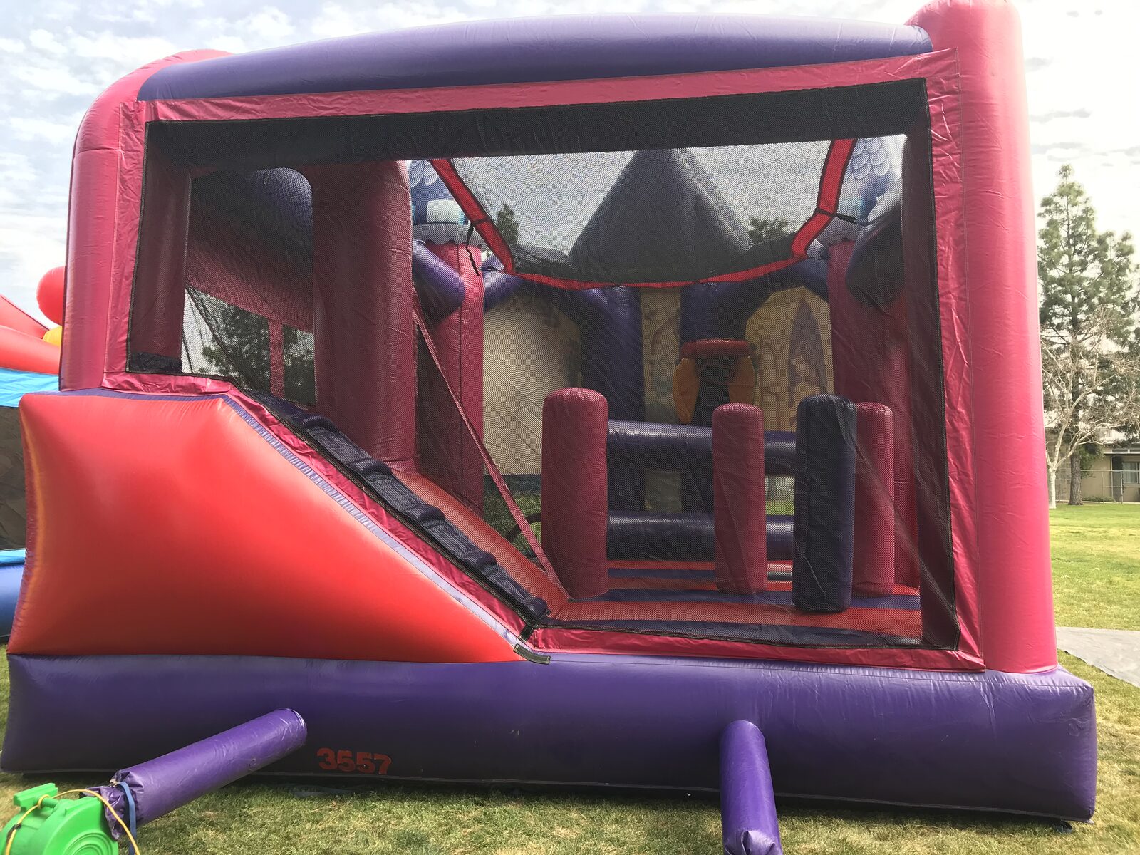 5n1 princess 3D combo bounce house rental in San Diego, wide view of the complete setup at a park