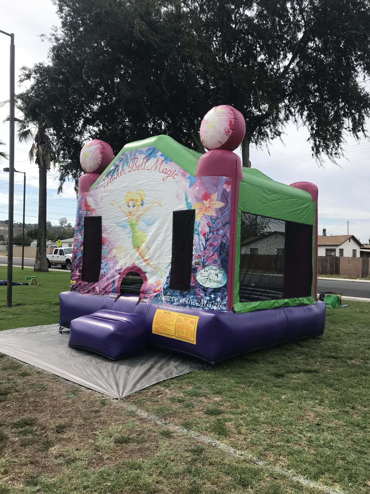 13x13 Tinkerbell bounce house rental in San Diego — side-angled view with the Disney Fairies artwork and entry ramp