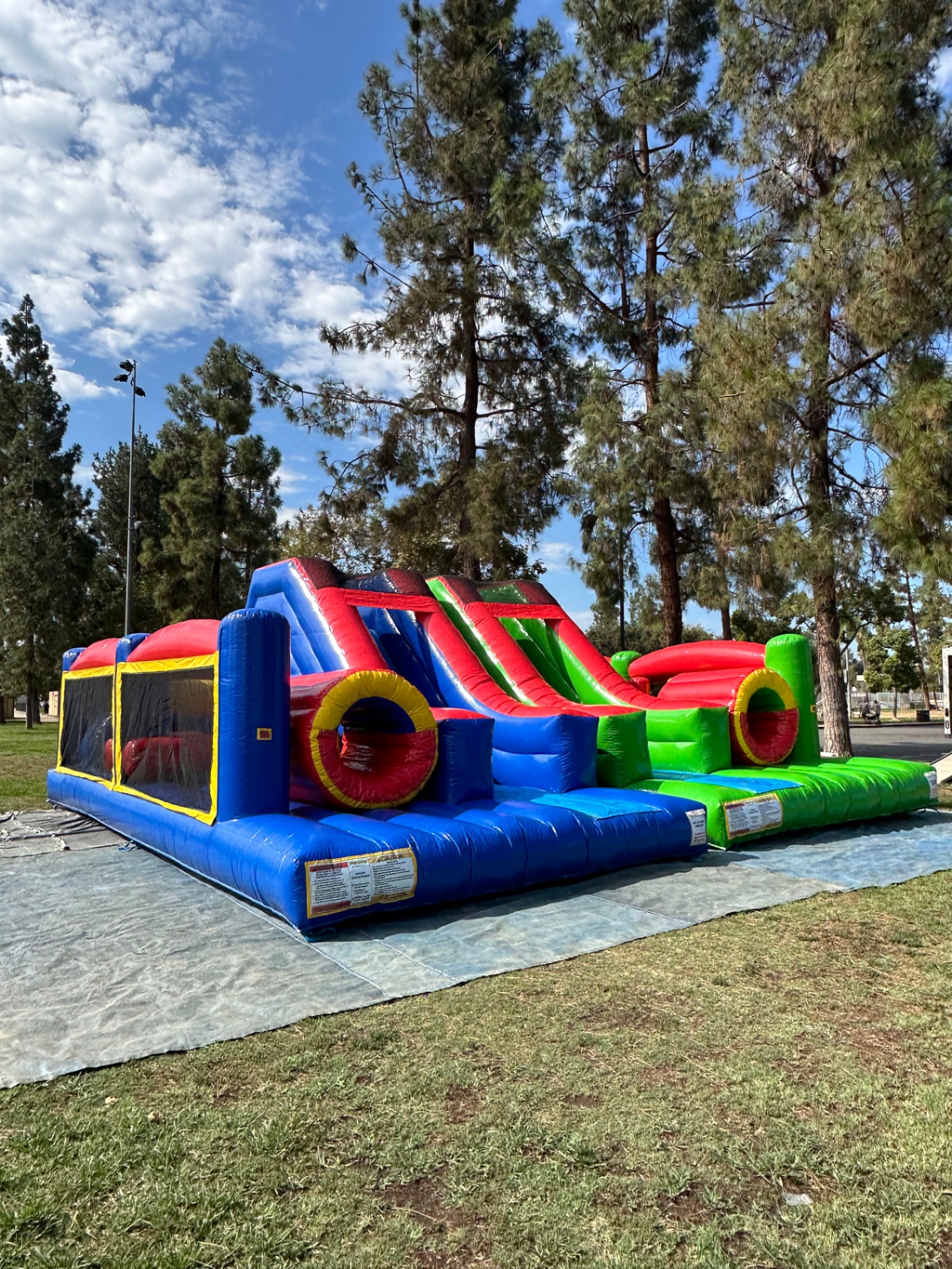Dual lane challenge course obstacle rental in San Diego, three-quarter view showing the full length of the blue and green lanes