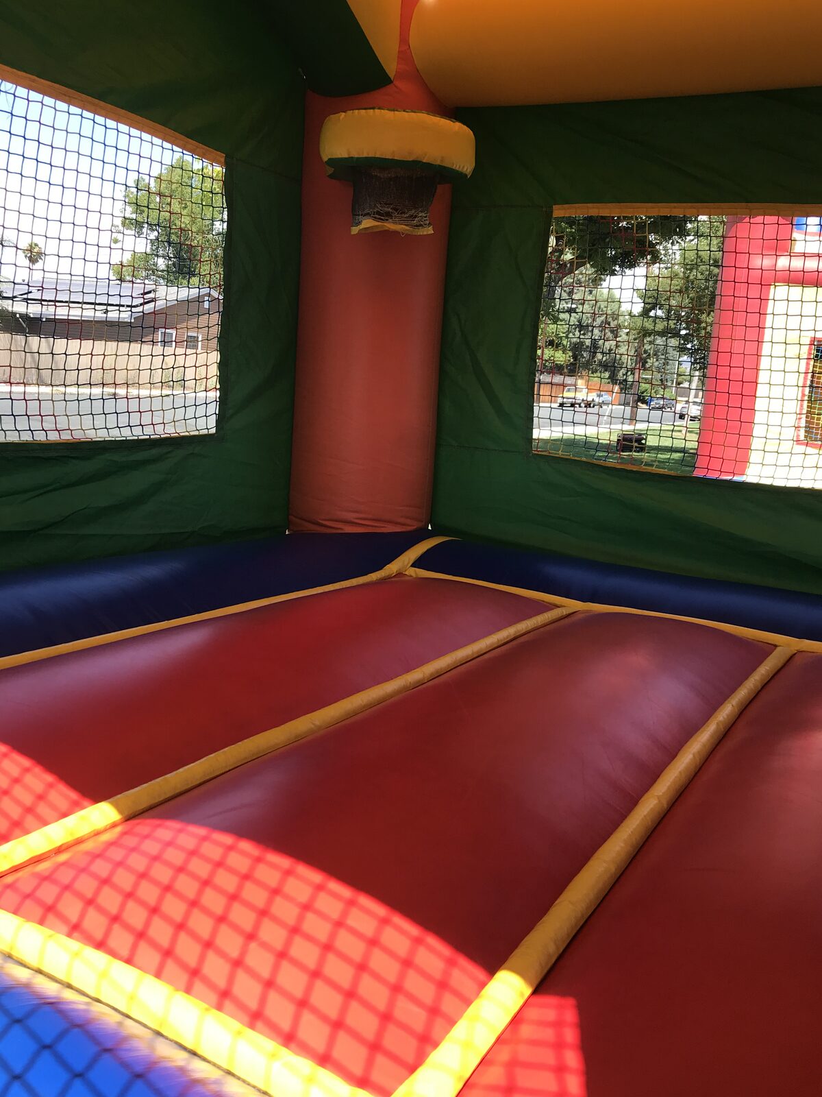 2n1 summer balloon combo bounce house rental in San Diego, interior view of the red jump floor and basketball hoop