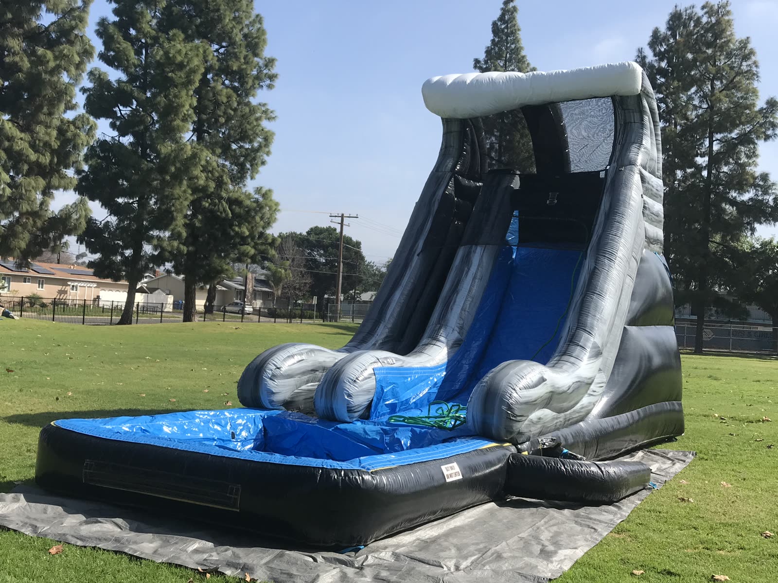 Water slide rental in San Diego, 18ft wave setup side profile showing the full slide length on grass