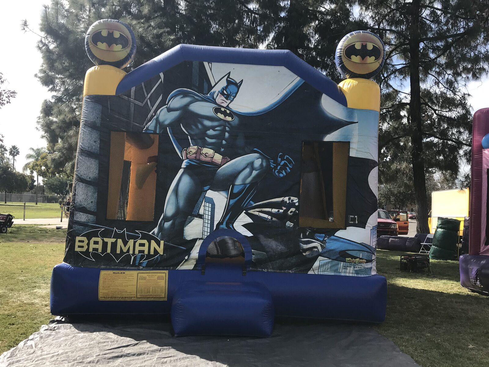 4n1 Batman combo bounce house rental in San Diego, close front view of the Batman artwork, entry step, and bat-signal towers
