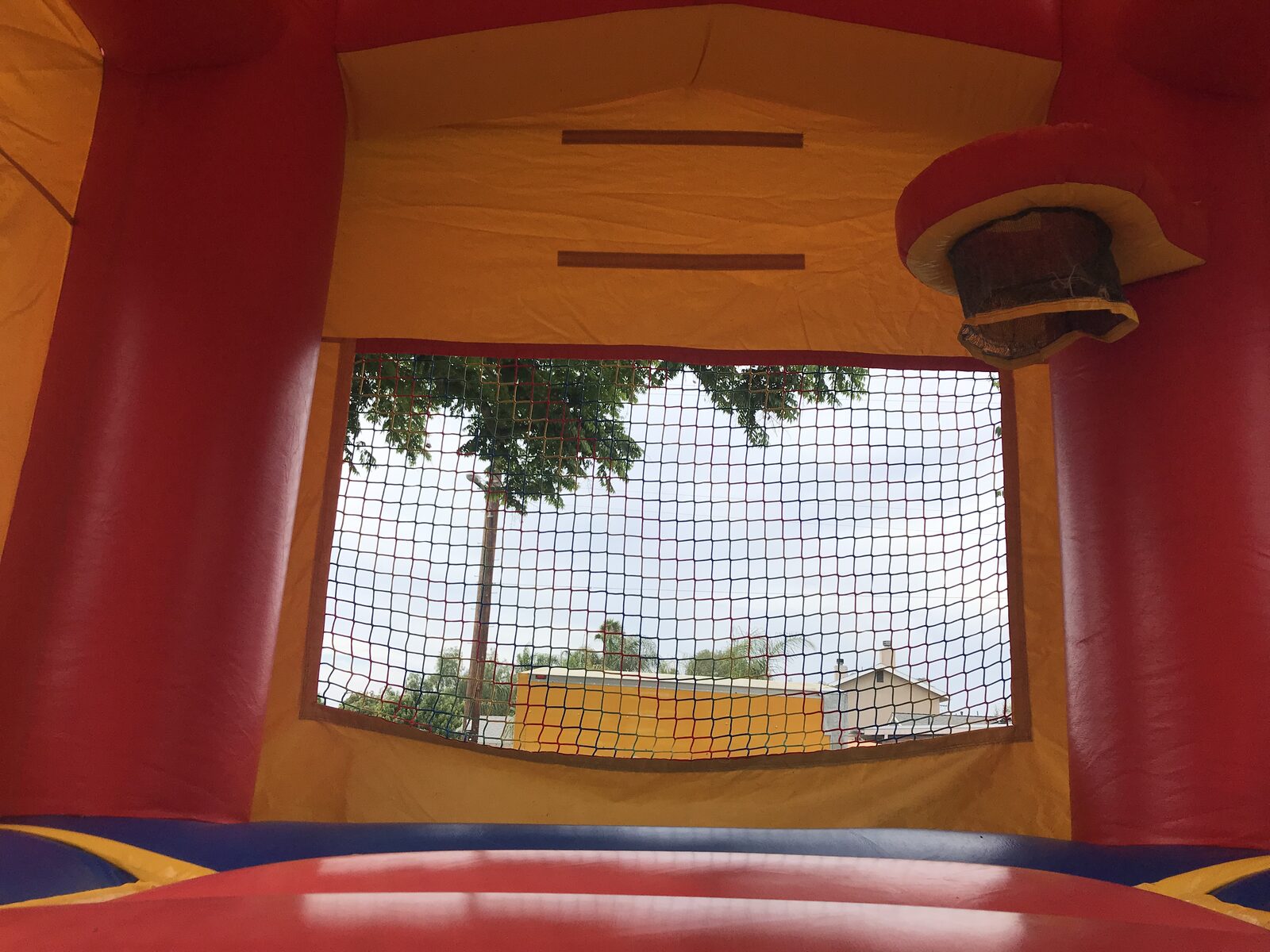 12x14 blue castle banner mini bounce house rental in San Diego, interior view with basketball hoop and mesh window