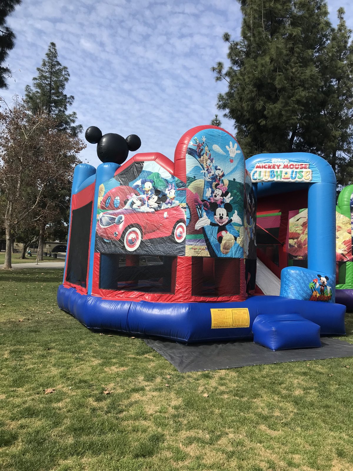 5n1 Mickey combo bounce house rental in San Diego, corner view of the Mickey car panel and 3D Mickey ears