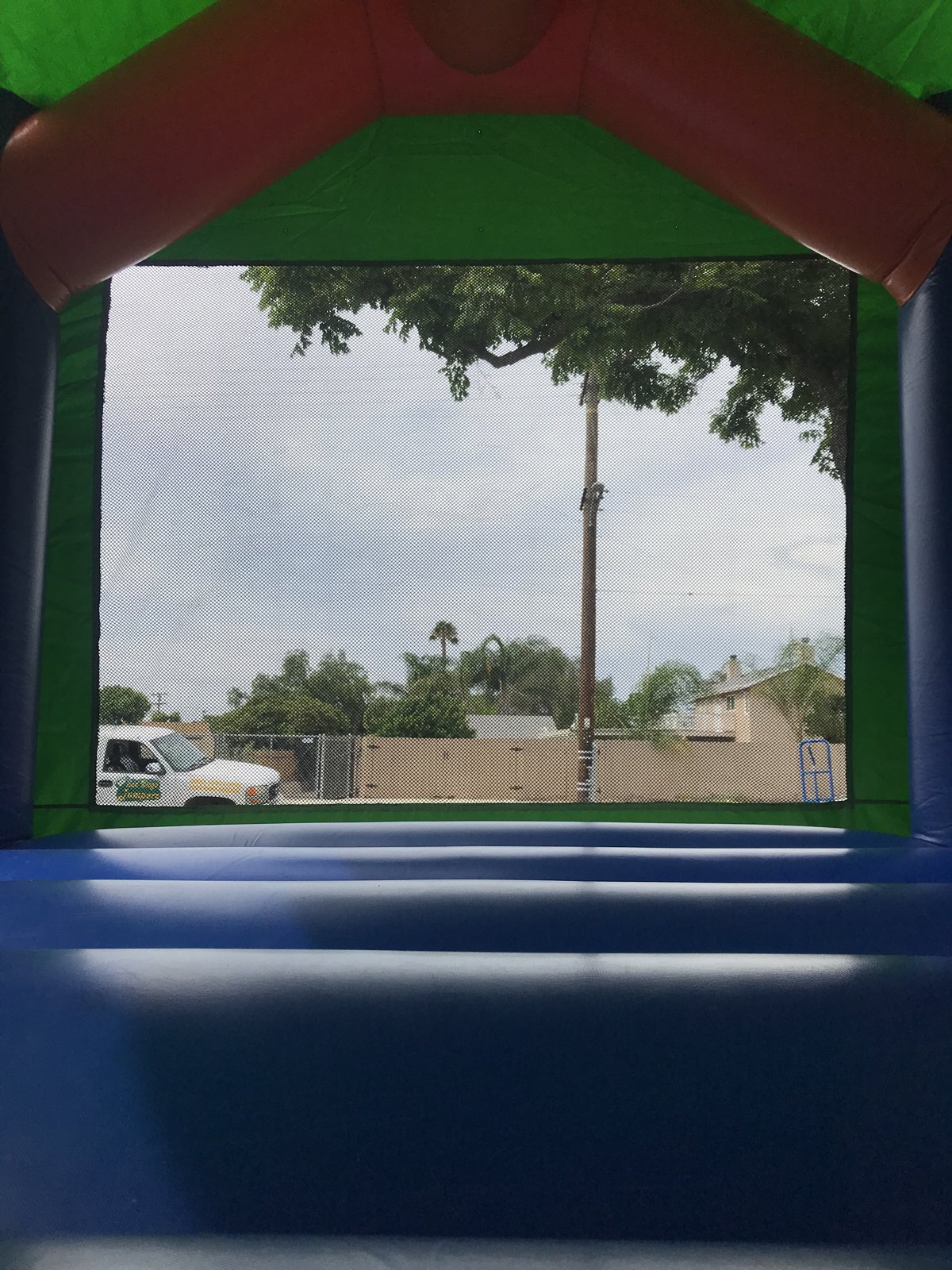 13x13 Original Spider-Man bounce house rental in San Diego — inside view of the blue jumping floor looking out the large mesh window