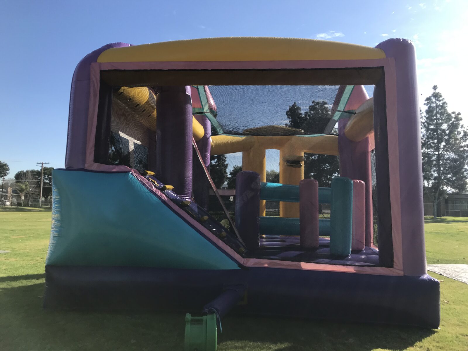5n1 dazzling castle combo bounce house rental in San Diego, back view of the slide, climb-up and pop-up obstacles inside