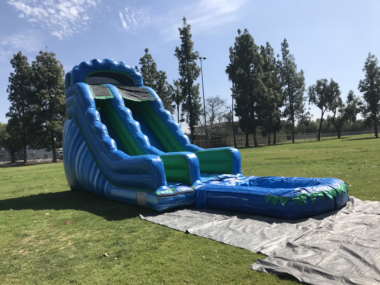 Water slide rental in San Diego, 20ft green and blue water slide side profile showing the tall tower height