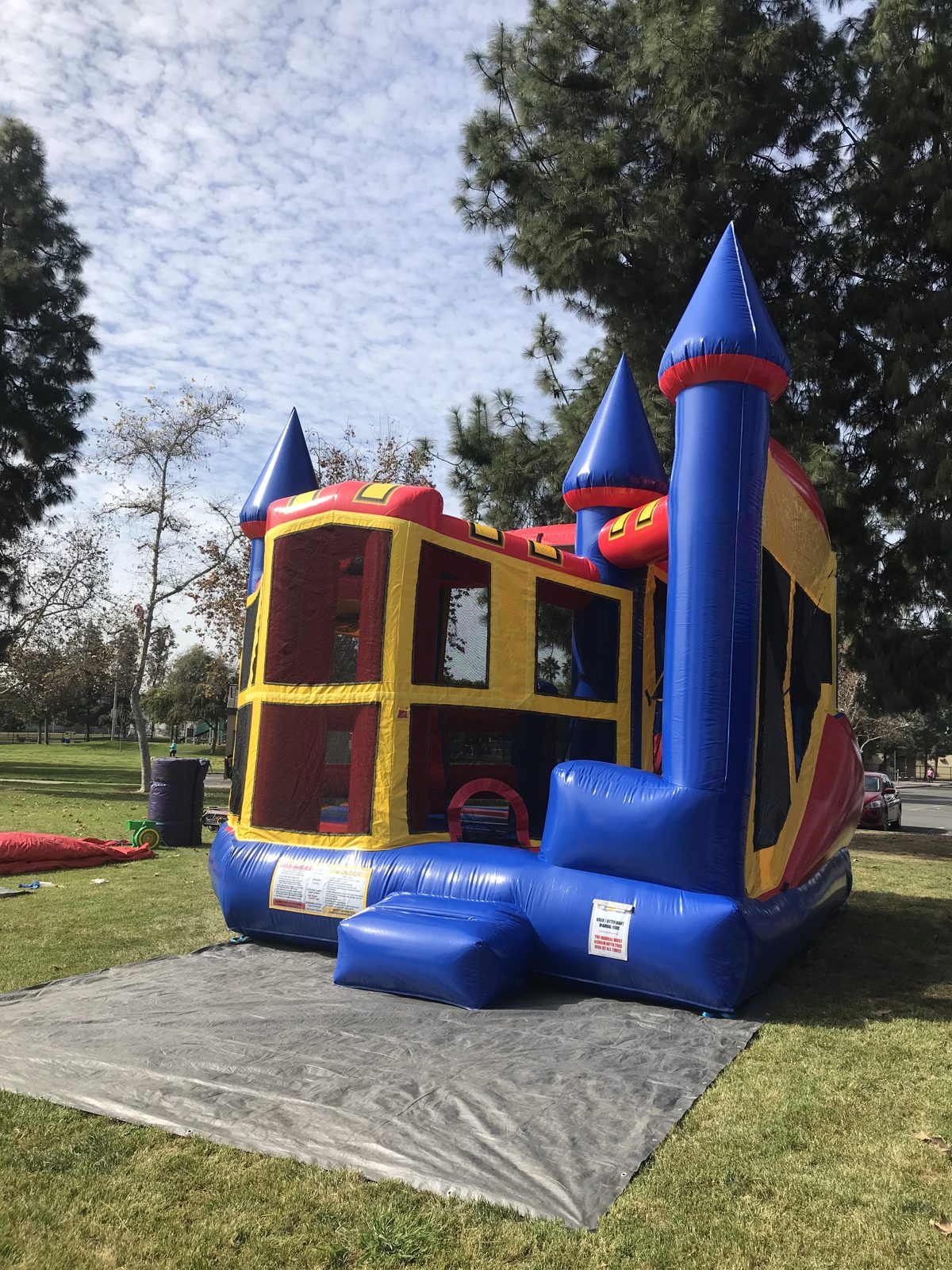 5n1 blue castle banner combo bounce house rental in San Diego, side view showing the blue turret tower and red side wall