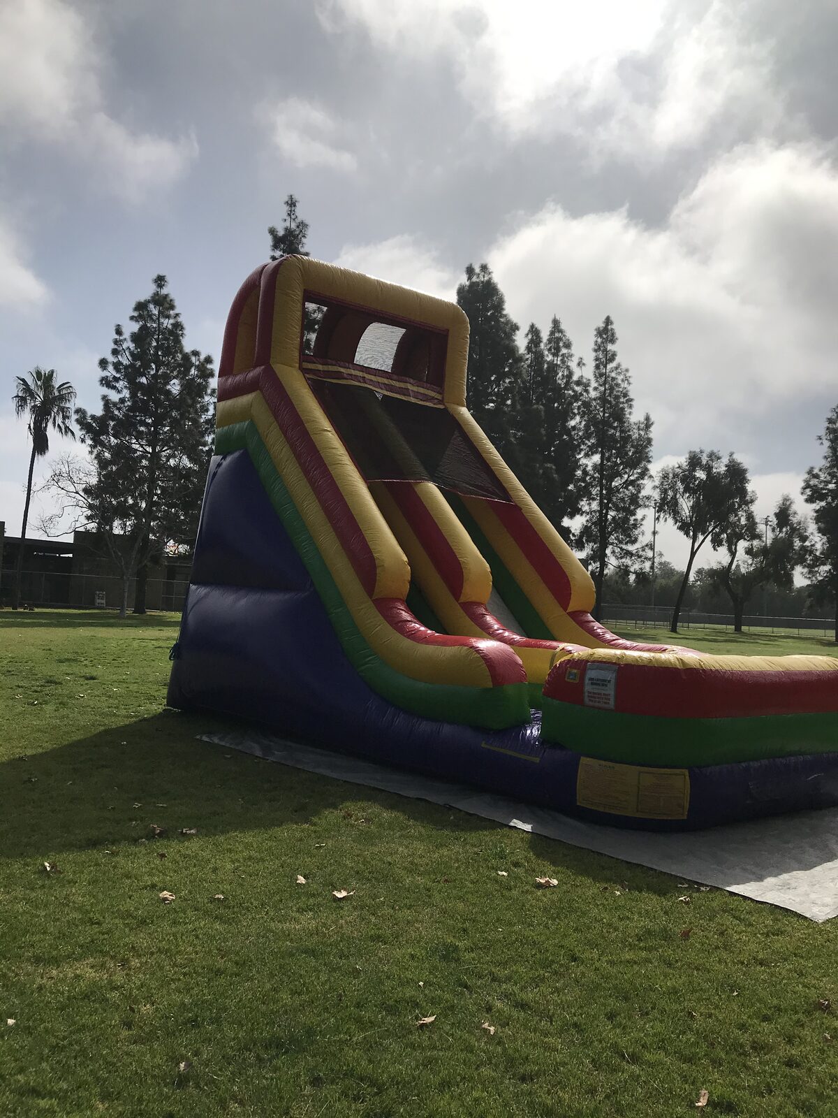 Dry slide rental in San Diego, 21ft single lane dry slide side view showing the climbing lane and landing