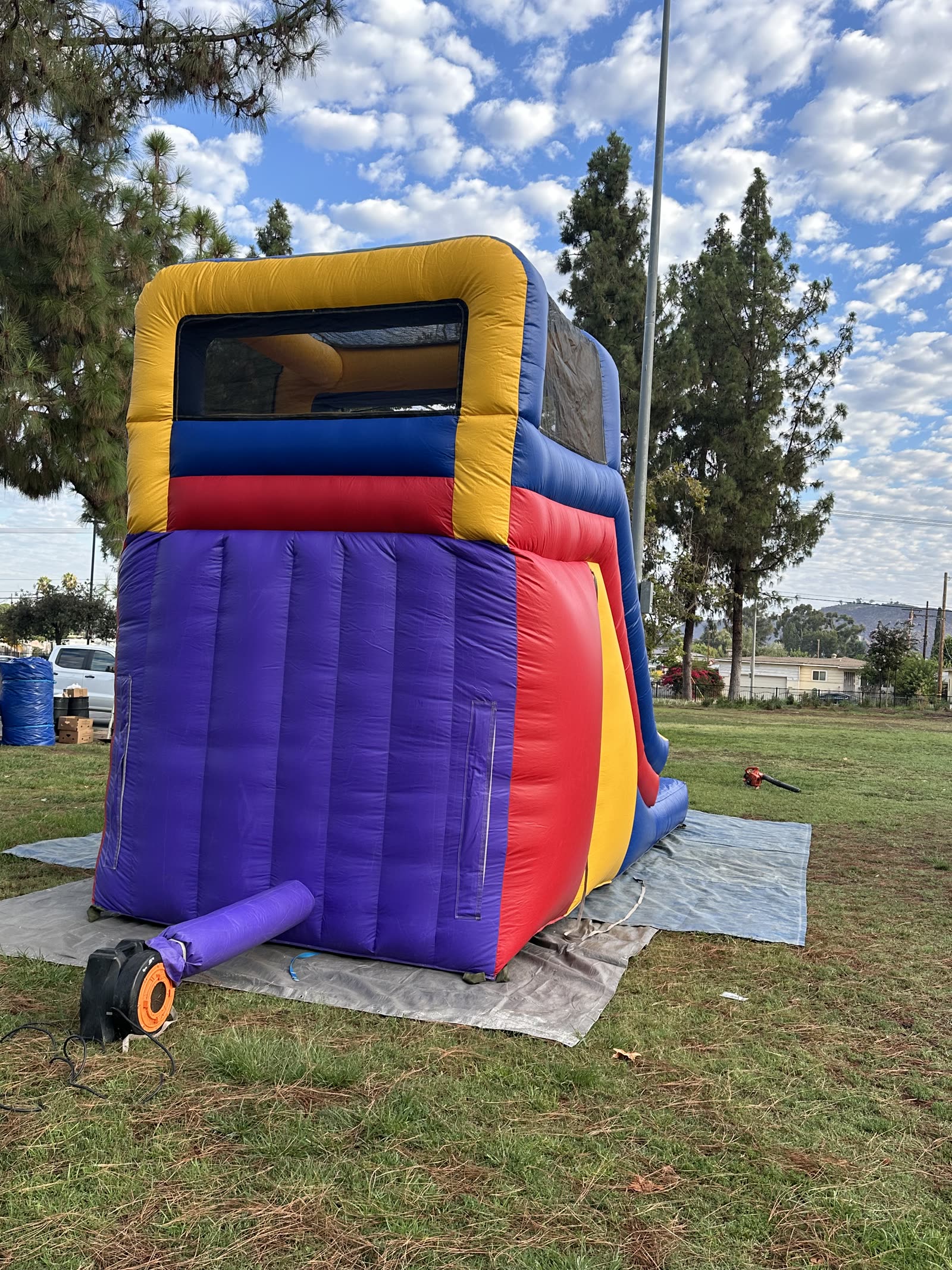 Water slide rental in San Diego, 15ft multi color water slide close view of the blue splash pool landing