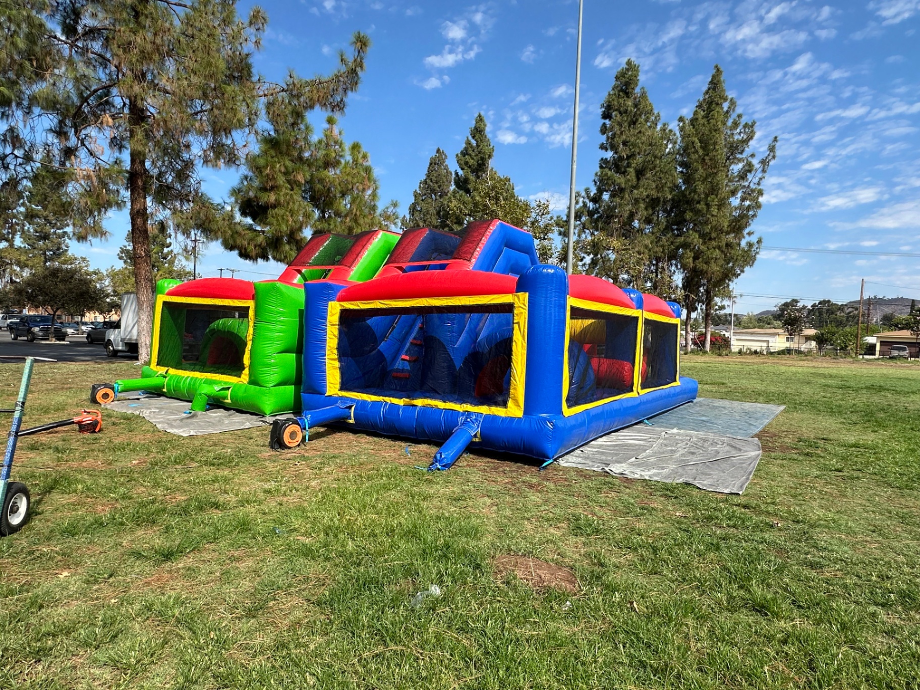 Dual lane challenge course obstacle rental in San Diego, back three-quarter view of the green and blue obstacle bays side by side