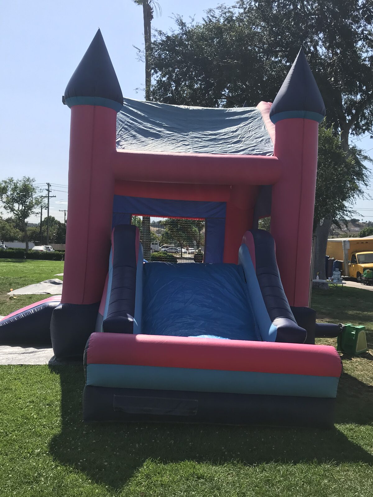 2n1 pink princess combo bounce house rental in San Diego, straight-on view of the slide exit and padded landing