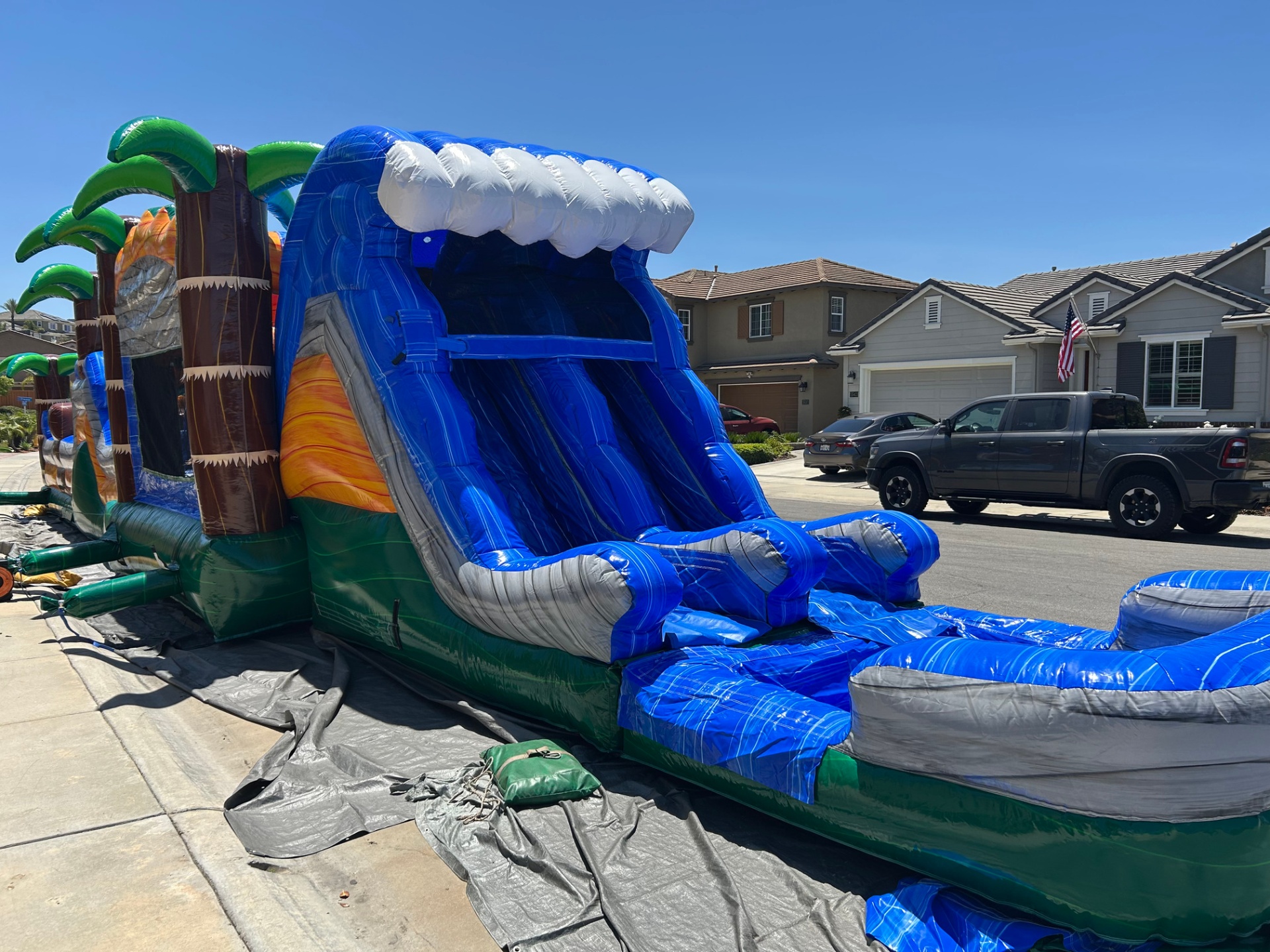 63ft tropical obstacle course rental in San Diego, close view of the curling wave top on the slide tower