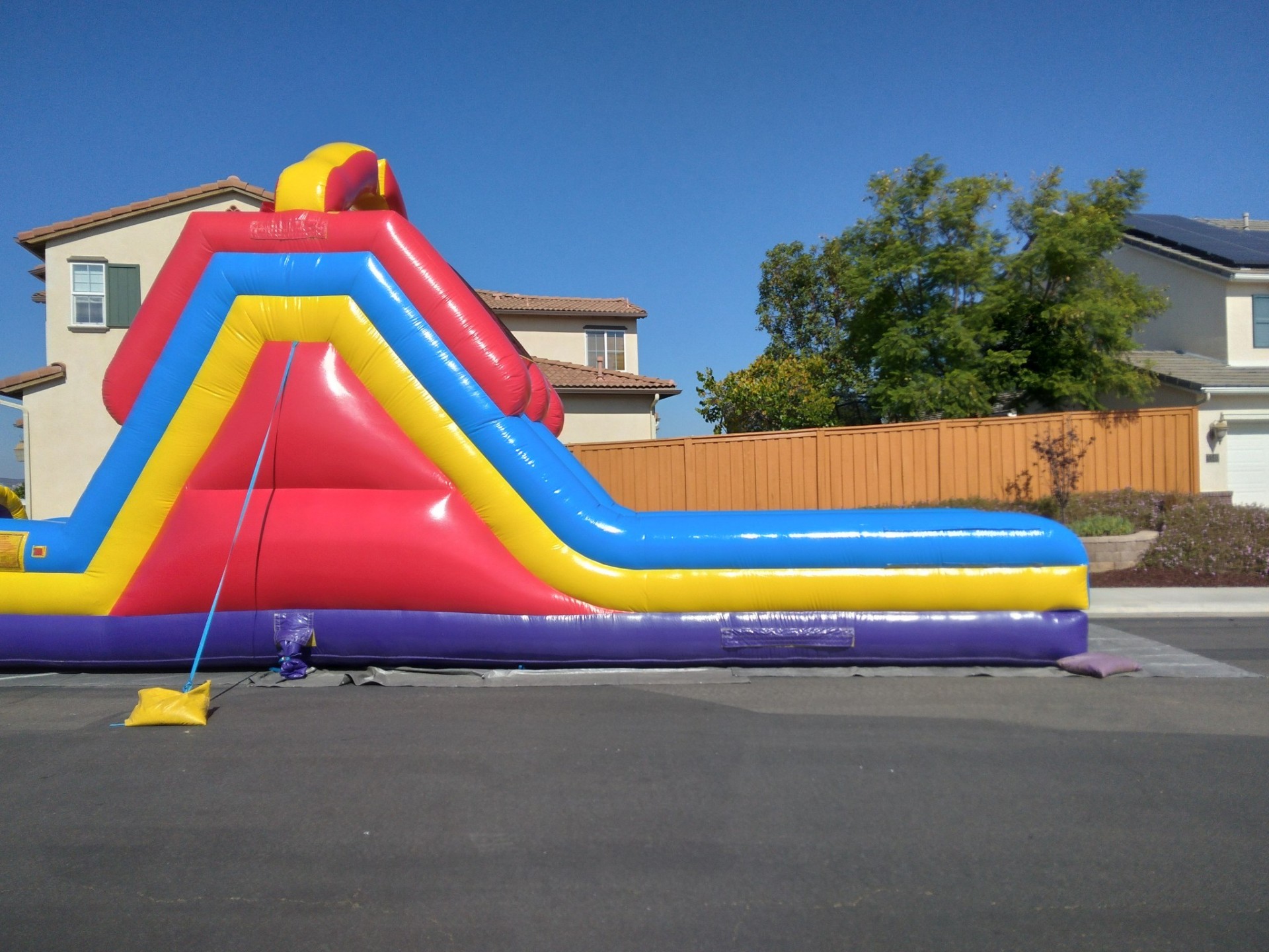 70ft monster obstacle course rental in San Diego, side profile of the slide ramp and long run-out landing