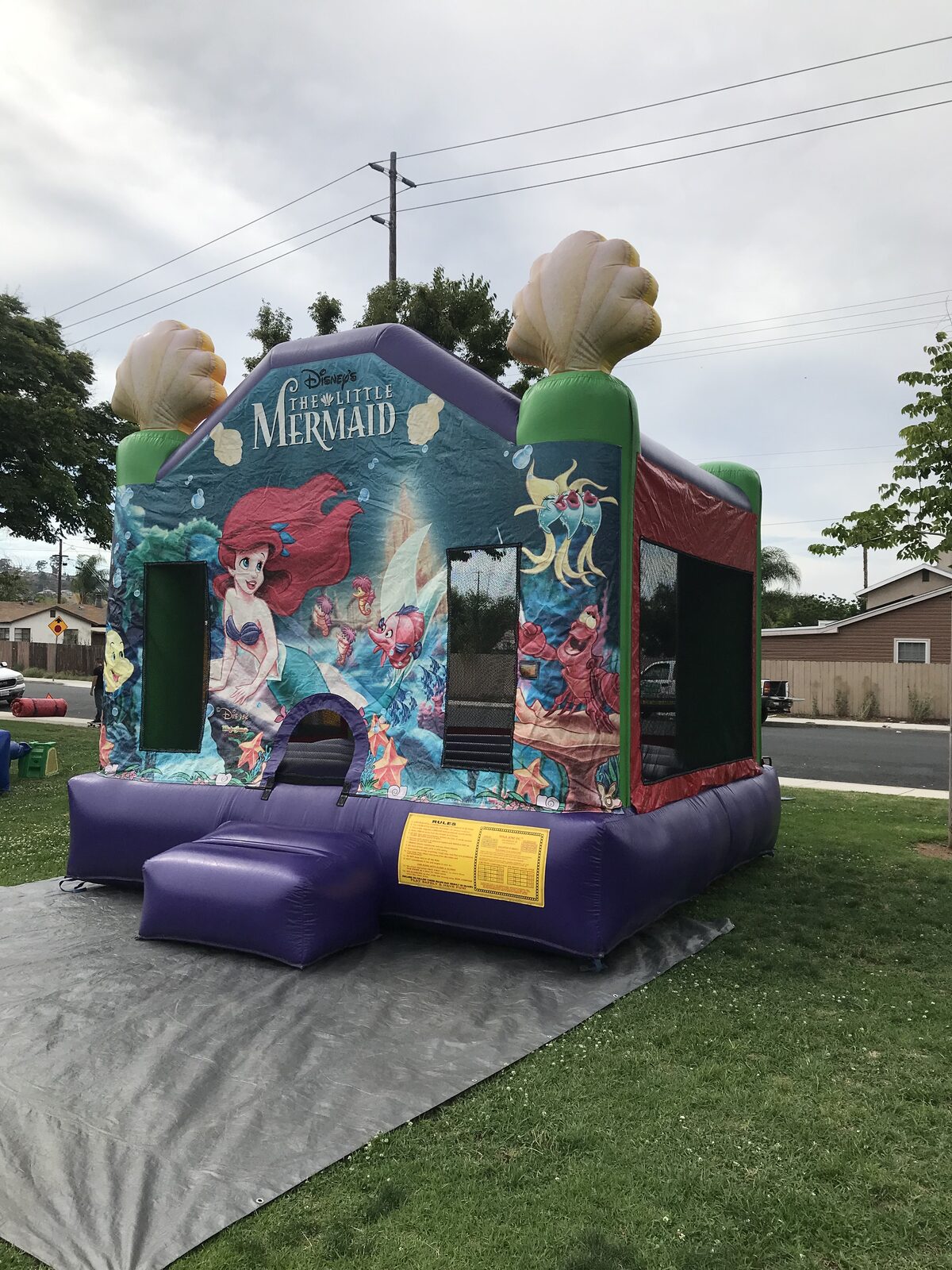 13x13 Ariel bounce house rental in San Diego — side-angled view showing the mesh safety windows and under-the-sea artwork