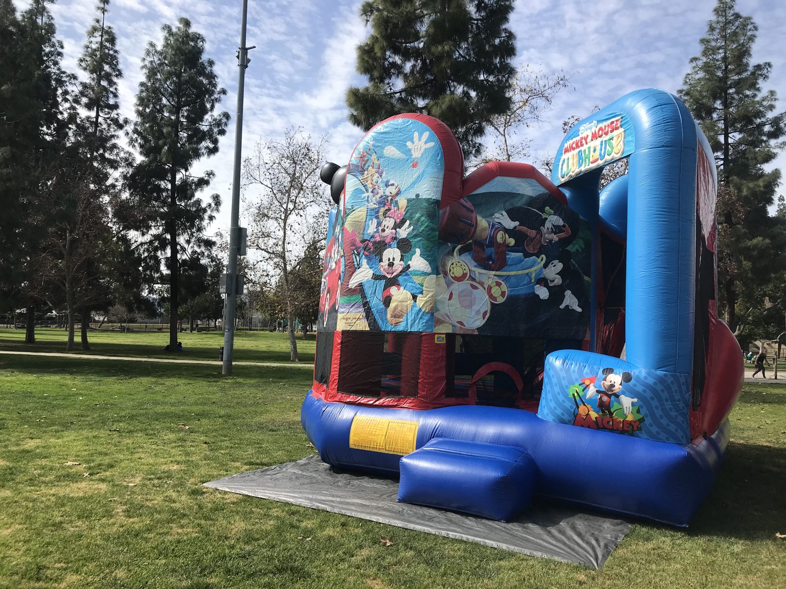 5n1 Mickey combo bounce house rental in San Diego, angled front view with the Clubhouse arch and slide