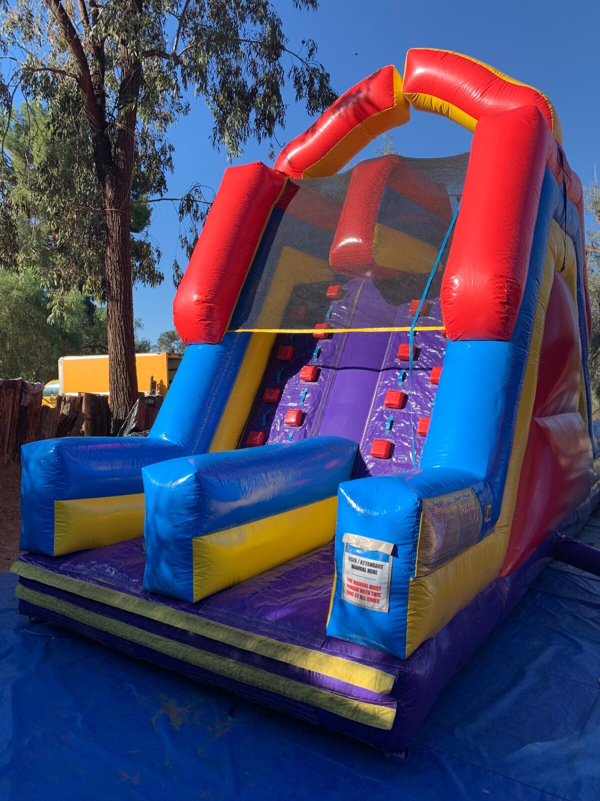 18ft dual lane monster obstacle course rental in San Diego, close view of the red-block climbing wall and mesh top