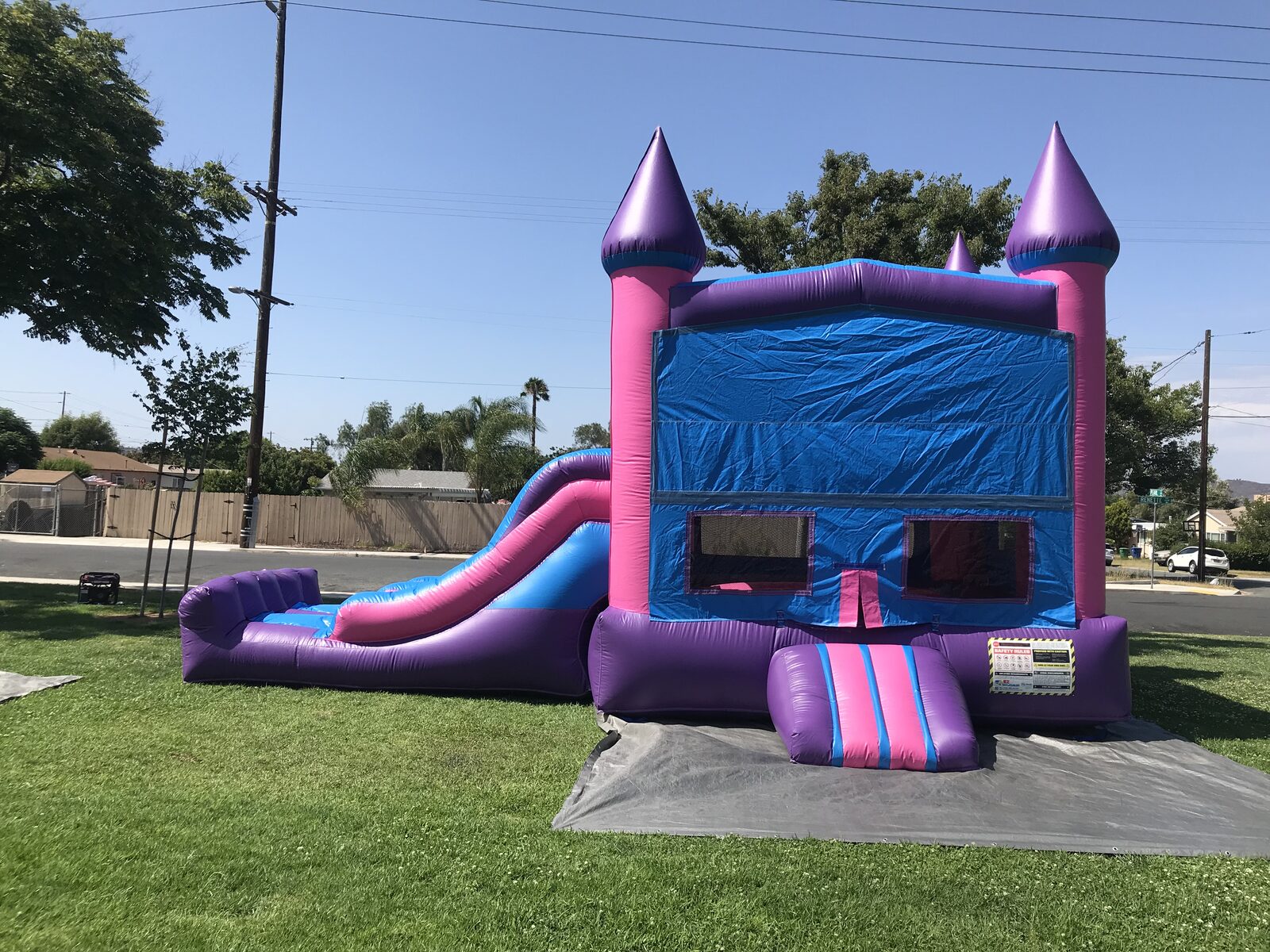 3n1 pink castle banner combo bounce house rental in San Diego, side view of the jump area with mesh safety windows