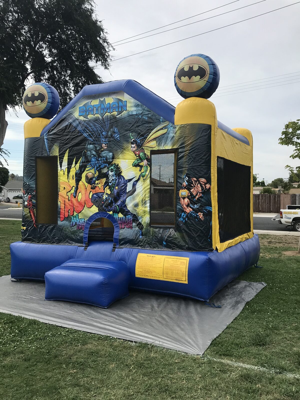 13x13 Batman bounce house rental in San Diego — front view with Batman, Robin, Joker, and Harley Quinn art panel and Bat-signal corner toppers